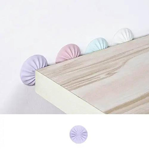 Silicone Door Stopper And Wall Protector Pad for quiet homes, installed on a wooden surface, showcasing pastel colors and circular design.