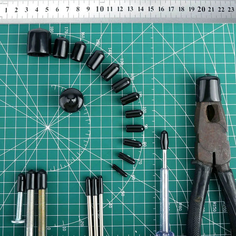 Round Rubber End Caps Set 158 Pieces With 12 Sizes on a green grid mat with tools