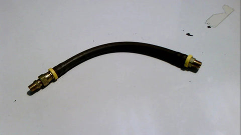 Curved black hose with brass fittings on a white surface.