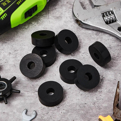 Eight piece set of thick rubber vibration isolation pads delivers solid damping for washers and appliances, absorbing impacts, reducing noise, and protecting floors. Pads shown with tools on concrete surface.