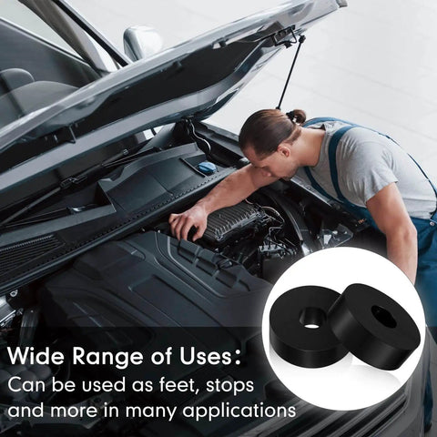 Mechanic working on car engine with eight piece set of thick rubber vibration isolation pads for washers and appliances shown