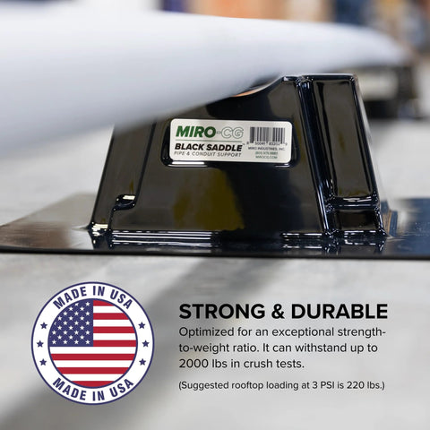 Black saddle rooftop pipe support holding a light gray conduit; MIRO-CG label and Made in USA seal visible.
