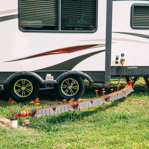 3 In 1 RV Sewer Hose Adapter And Drain Seal With RhinoExtreme Hose and Handle connected to RV, showing flexible universal fit in use.