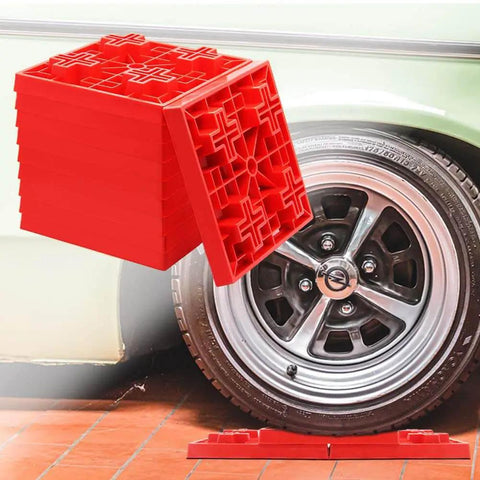 10 Pack Heavy Duty RV Leveling Blocks For Campers And Trailers Interlocking red plastic blocks next to RV wheel