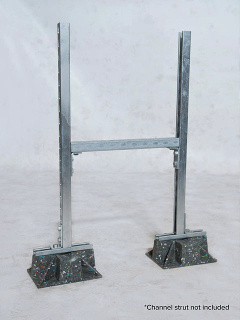 Saddle rooftop pipe stand with two vertical metal rails, perforated crossbar, and speckled weight bases.