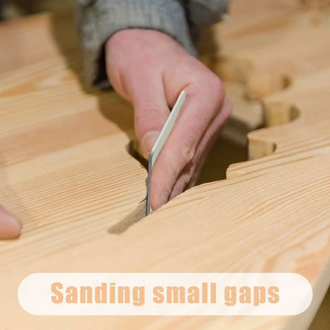 Close-up of hand using Double Sided Sanding Pads Kit 30 Pcs 2x2 In For Plastic And Acrylic Grit 320 600 on wooden surface