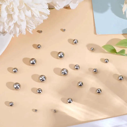 5 Size Set Of Screw Ball Backings For Threaded Posts 304 Stainless Steel Round Earring Backs scattered on a surface