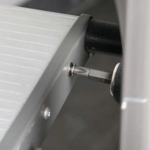 Close-up of stainless steel screw from Nuts And Bolts Assortment Kit 900 Pcs being installed into metal frame.
