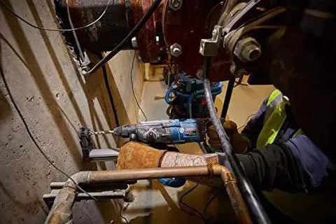 Worker using One And One Eighth Inch SDS-Plus Bulldog Xtreme Max Rotary Hammer For Concrete Drilling And Chiseling In Masonry
