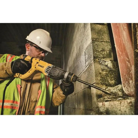 Worker using a lightweight corded SDS rotary hammer with Active Vibration Control to drill into concrete wall, showcasing 3.0 J impact energy.