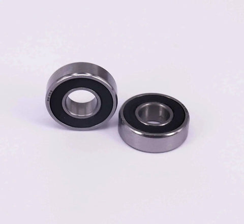 Two chrome-plated 10 Sealed Bearing R6-2RS 3/8''x 7/8''x 9/32'' miniature ball bearings with rubber seals on a white background