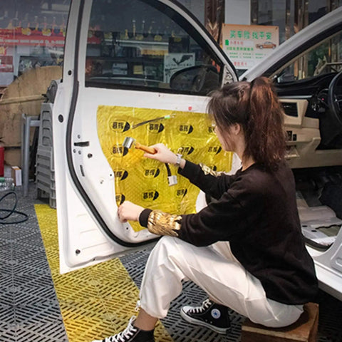 Person using Pro Grade Seam Roller Hand Roller With Anti Slip Ergonomic Steel Roller on car door sound deadening material
