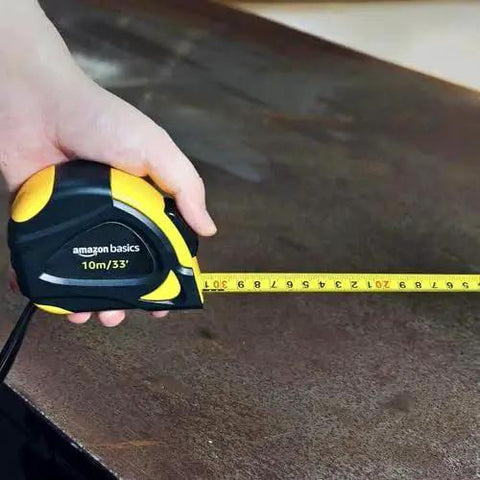 Self locking tape measure with belt clip offers precise 33 feet of measurement with MID accuracy, shown in hand on table.