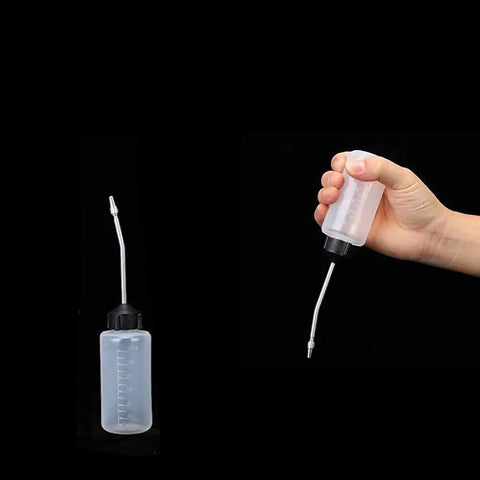 Sewing Machine Oil Dispenser 120ml Two Pack With Screw On Cap Extended Spout Angled Nozzle shown in hand and upright position