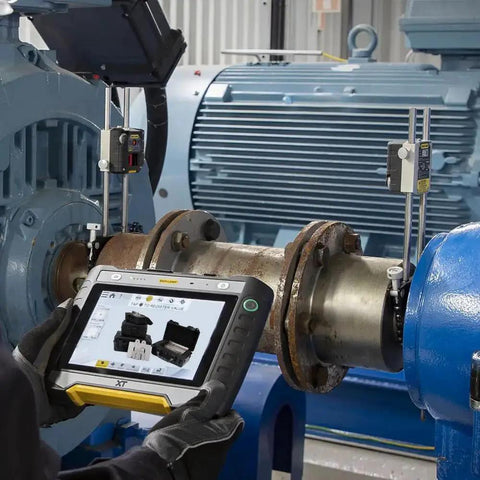 Technician using a device to align machinery with 304 Stainless Steel Slotted Shims for leveling and machining in an industrial setting.
