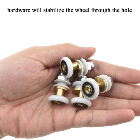 Hand holding 20mm diameter brass shower door wheels with nylon rollers, stainless steel screws, and ball bearings for easy install.