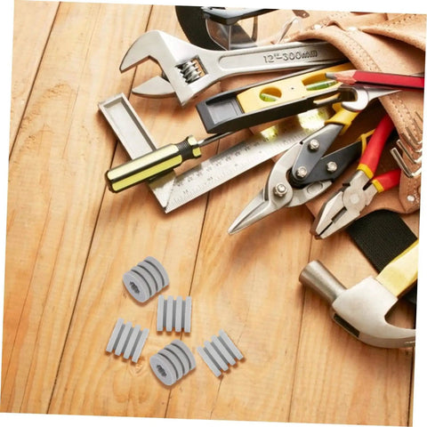 Silicone Antiskid Pads Set 20 Pack Non Slip Bumpers For Chassis And Furniture Feet next to tools on wooden background