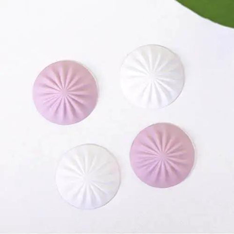 Soft silicone door stopper and wall protector cushions door impacts, reduces noise, and prevents furniture scratches shown in pink and white.