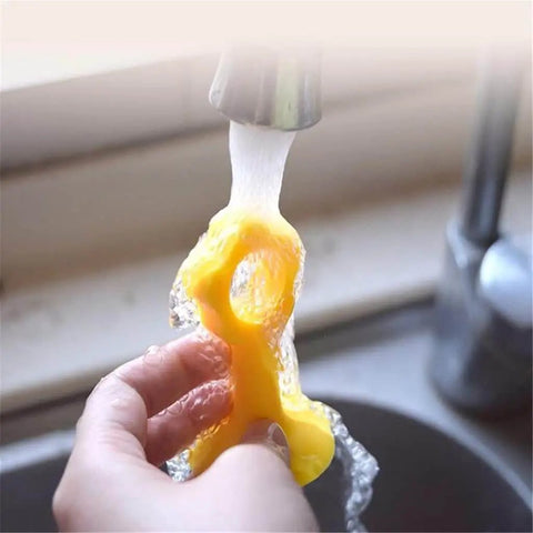 Hand washing silicone door stopper and wall protector under running water for easy cleaning