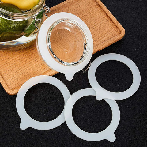 White silicone jar gasket rings, 3.75 inch, for regular-mouth canning jars; four replacement seals.