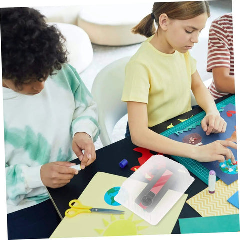 10 Piece Silicone Mold Covers For Handmade Jewelry And DIY Projects Dustproof Shield Plastic Protective Covers visible on craft table with kids.