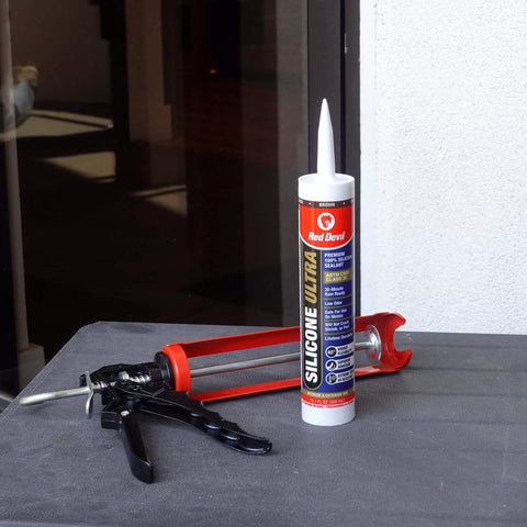 Ultra 100 Percent RTV Silicone Sealant For Exterior Weatherproofing Easy To Apply Neutral Cure Formula Bonds To Metal Wood Glass Concrete 10.1 Oz Brown 1 Pack tube standing with a caulking gun