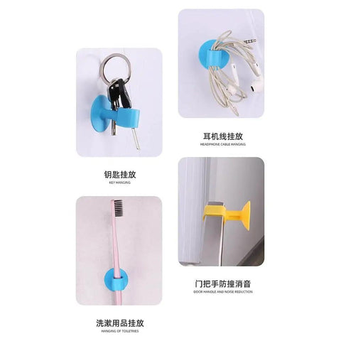 Soft silicone door handle bumper absorbs impact and noise, protecting walls, shown in vibrant orange with keys, earphones, toothbrush.