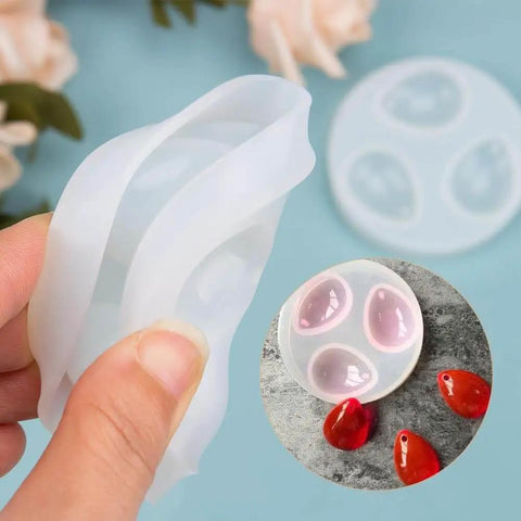 Close-up of Water Drop Pendant Silicone Molds For Resin Casting Jewelry Making 2 Pack With Hole Easy Release and red resin pendants.