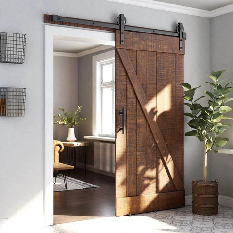 6ft Heavy Duty Sliding Barn Door Hardware Kit, Black, installed in a living room, wood door with industrial wheel hangers