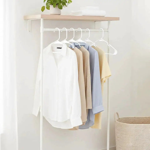 Space saving 50 pack slim plastic hangers provide durable, lightweight closet organization for apartments and dorm rooms showcasing shirts