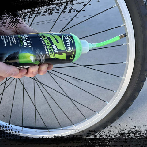 Slime 10193 Tire and Tube Sealant Puncture Repair Sealant, 2-in-1, Premium being applied to bicycle tire with non-toxic formula