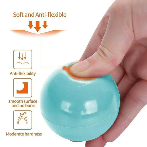 Hand squeezing a soft, anti-flexible, crush-proof BPA free pastel pit ball with smooth surface and no burrs, for toddler use.