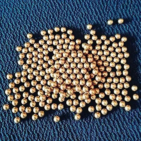 100pcs 1.8mm solid brass balls for electric switches machine precise copper ball scattered on a textured blue surface