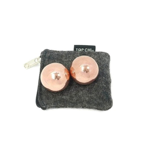 1 inch Solid Copper Baoding Balls with Carry Pouch for Hand Therapy, Exercise, and Stress Relief, shown on gray pouch