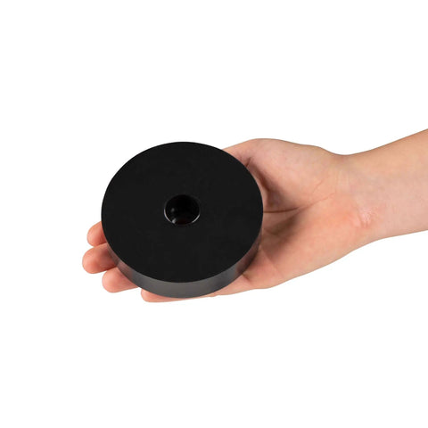 Hand holding Sorbothane anti vibration leveling mount, 3/8-16 threaded, 3 inch stud, 0.88 inch height, 3.5 inch diameter