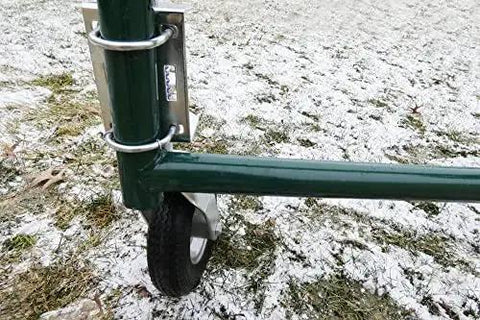Heavy Duty Flat Free Spring Gate Caster with 8-inch wheel mounted on green gate, snow-covered ground
