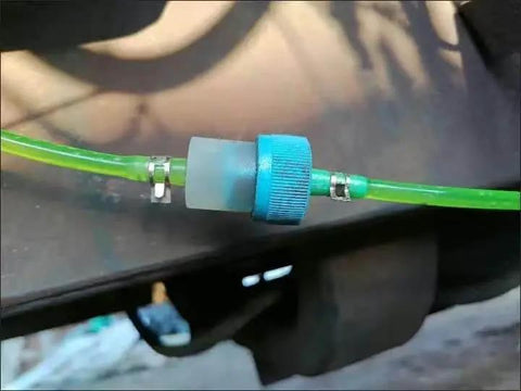 Installed 50 Piece 13mm Half Inch Spring Hose Clamps Kit For Low Pressure Air Lines on green hose, visible connector.