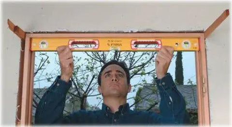 Man using Stabila 37816 48 Inch And 16 Inch Aluminum Box Beam Level Set with German accuracy for framing in construction project