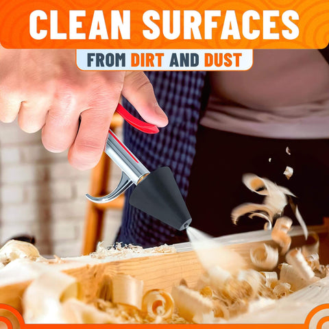 Person using Heavy Duty Stainless Steel Air Nozzle Blow Gun For Compressor With Adjustable Pressure Rust Resistant Brass Threads Rubber Tip Thumb Switch Lever Compact HVAC Tool For Cleaning Tight Spaces on wood carving surface.