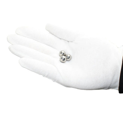 Gloved hand holding three Stainless Steel Bearing Balls One Quarter Inch Pack Of 100 For Bicycles Motorcycles And Auto Parts 304 Grade