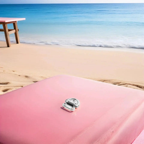 One marine-grade stainless steel folding D-ring tie-down anchor on pink beach surface