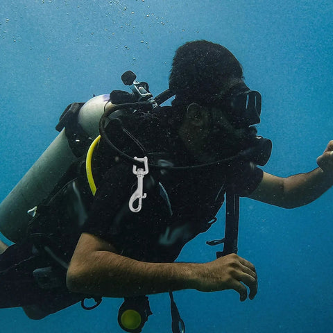 Front view of a 100mm stainless steel trigger snap clip attached to scuba gear.