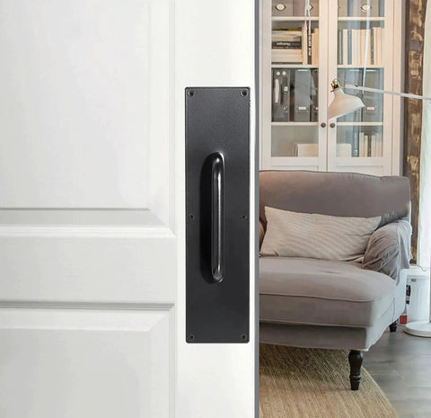 Two Piece 16 Inch Stainless Steel Door Handle Pull And Push Plate Set installed on a white door near a cozy room, brushed black finish