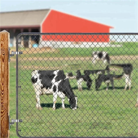 Rugged stainless steel gate hinge set for outdoor use with two pack wall mount hinges attached to farm gate with cows in background.