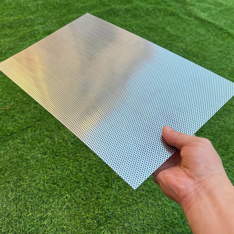 Person holding Stainless Steel Perforated Sheet 16x10 In, 304 Grade, 19 Gauge With 1/16 Inch Openings on grass