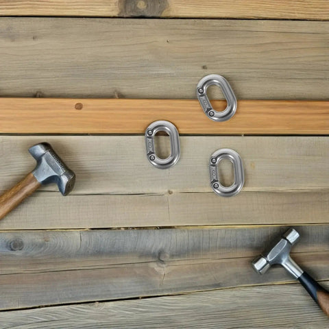 Three 8mm marine-grade 316 stainless steel quick links on wooden planks