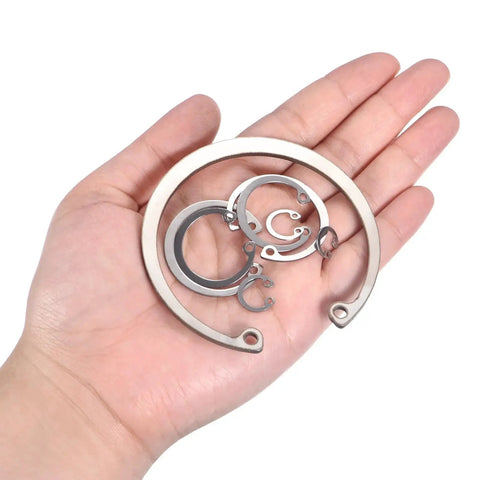 Hand holding Heavy Duty Internal Retaining Ring Circlip for Grooved Shafts and Studs 2 Pack by Uxcell 304 Stainless Steel