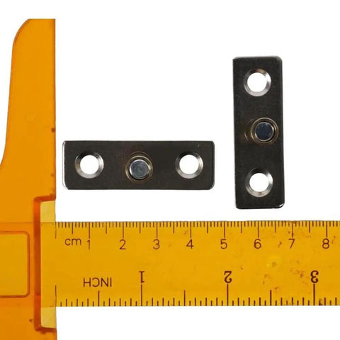 4 Pcs Stainless Steel Roller Guides For Sliding Barn Doors Floor Guides And Hardware Accessories with ruler for scale.