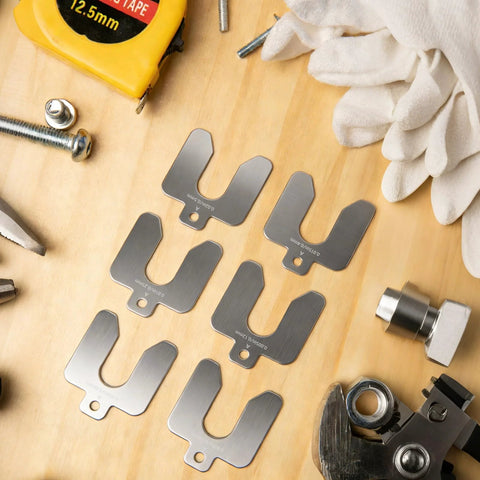 96 Piece Slotted Stainless Steel Shim Kit For Leveling And Precision Fit 2X2 Inch Shims, tools and gloves on wooden surface.