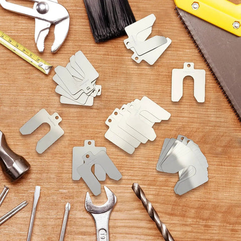 Stainless Steel Slotted Shims Kit 260 Piece Set With Storage Box 3 By 3 Inches Leveling Shims Assortment scattered on wooden surface